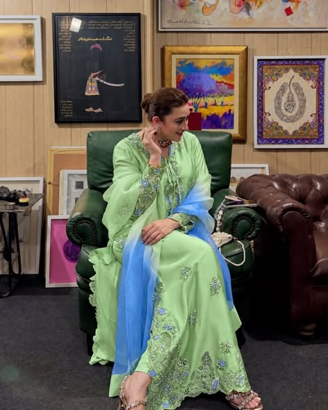 Seated model styling reference showing the embroidery and dupatta