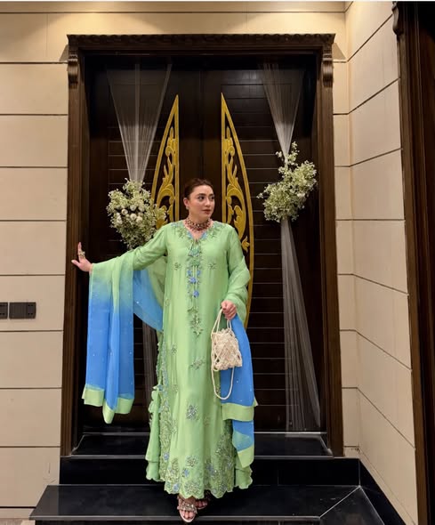 Model styling reference for a green embroidered suit with a blue dupatta