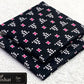 All-Over Printed Khaddar - 2-Piece Unstitched Suit; Black and Pink Motif, actual fabric and design detail.