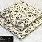 All-Over Printed Khaddar - 2-Piece Unstitched Suit; Ivory and Black Bandana, actual fabric and design detail.