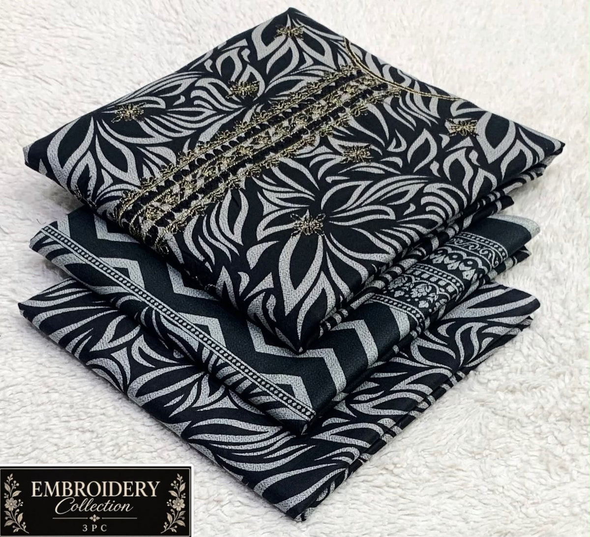 Printed Dhanak with Neckline Embroidery - 3-Piece Unstitched Collection; Black and Ivory Leaves, actual fabric and design detail.
